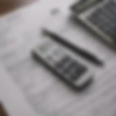 A close-up of tax forms with a calculator and pen